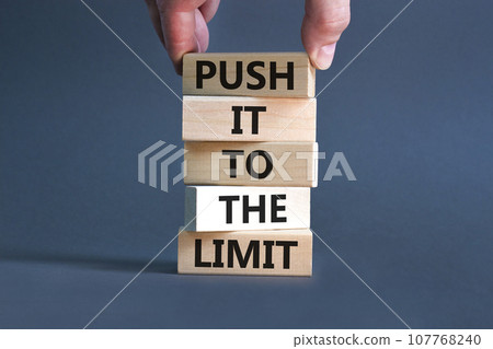 Push it to the limit symbol. Concept words Push it to the limit on wooden blocks. Beautiful grey table grey background. Businessman hand. Business push it to the limit concept. Copy space. Push it to the limit symbol. Concept words Push it to the limit on wooden blocks. Beautiful grey table grey background. Businessman hand. Business push it to the limit concept. Copy space. 107768240