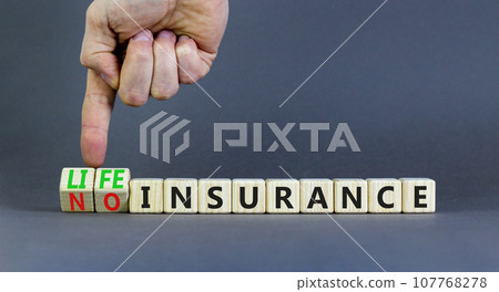 Life or no insurance symbol. Concept words Life insurance No insurance on wooden blocks. Beautiful grey table grey background. Businessman hand. Business Life or no insurance concept. Copy space. Life or no insurance symbol. Concept words Life insurance No insurance on wooden blocks. Beautiful grey table grey background. Businessman hand. Business Life or no insurance concept. Copy space. 107768278
