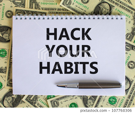 Hack your habits symbol. Words 'Hack your habits' on white note. Beautiful background from dollar bills, metallic pen. Business, psychology and hack your habits concept. Copy space. Hack your habits symbol. Words 'Hack your habits' on white note. Beautiful background from dollar bills, metallic pen. Business, psychology and hack your habits concept. Copy space. 107768306