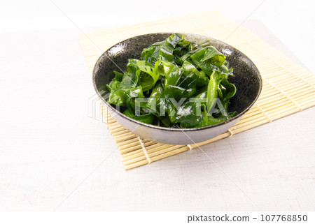 Laminaria (Kelp) Seaweed in black ceremic bowl. Japanese healthy food. Laminaria (Kelp) Seaweed in black ceremic bowl. Japanese healthy food. 107768850