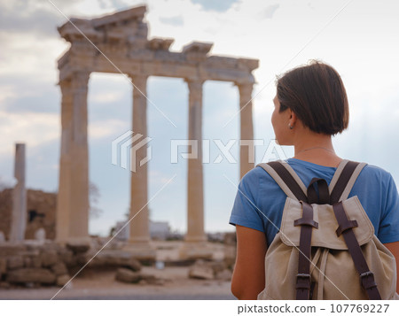 travel to ancient city of Side, Antalya coast of Turkey in tourist low season. Young tourist Asian woman is posing in front of temple of Apollo travel to ancient city of Side, Antalya coast of Turkey in tourist low season. Young tourist Asian woman is posing in front of temple of Apollo 107769227