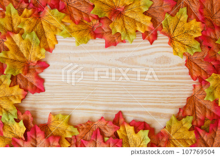 maple leaf and free space for text with wooden background. maple leaf and free space for text with wooden background. 107769504
