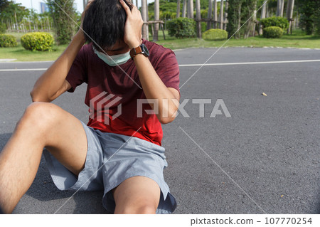The man is tired from a workout rest. Man athlete suffering a headache and dizziness. 107770254