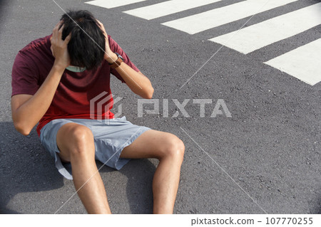 The man is tired from a workout rest. Man athlete suffering a headache and dizziness. 107770255