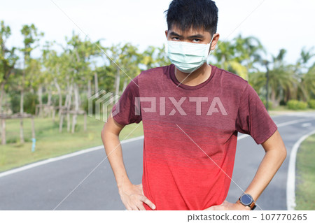 Sport man in medical protective mask. He warm up before running. exercise concept. Warm up concept. 107770265