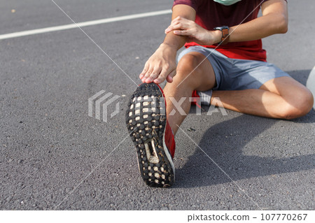 man in medical protective mask. He warm up before running.workout concept man in medical protective mask. He warm up before running.workout concept 107770267