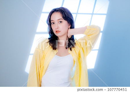 A young woman looking at the camera A young woman looking at the camera 107770451