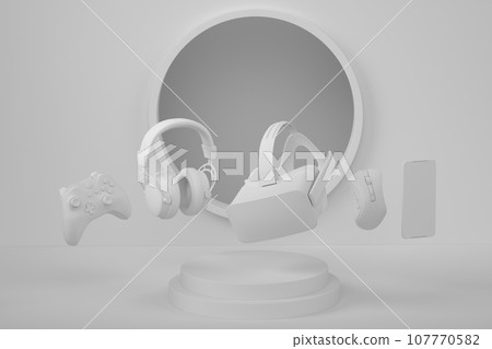 Set of video game joystick, VR glasses and headphones on monochrome podium 107770582