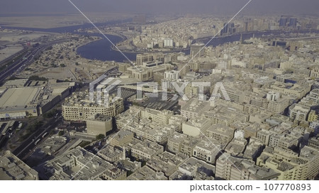 The Buildings In The Emirate Of Dubai. Aerial view. Dubai, United Arab Emirates. Aerial view of the business district of Dubai. Shooting in the summer haze of heat 107770893