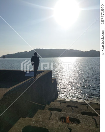 Two people staring at the sunset Two people staring at the sunset 107771940