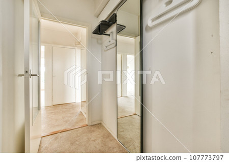 an empty room with a mirror hanging on the wall and two closet doors open to reveal a walk - in closet an empty room with a mirror hanging on the wall and two closet doors open to reveal a walk - in closet 107773797