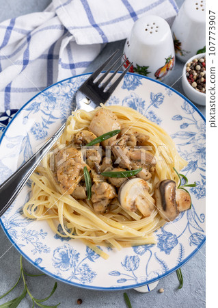 Pasta (linguini) with chicken and mushrooms. Pasta (linguini) with chicken and mushrooms. 107773907