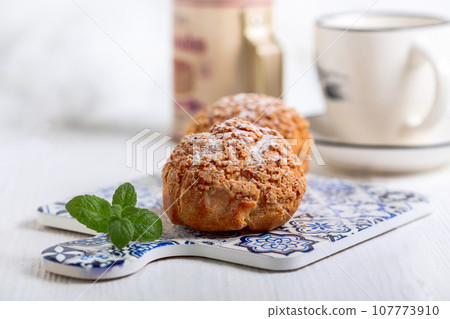 Choux cakes with custard. Choux cakes with custard. 107773910
