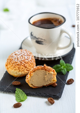 Homemade choux with coffee cream. Homemade choux with coffee cream. 107773912