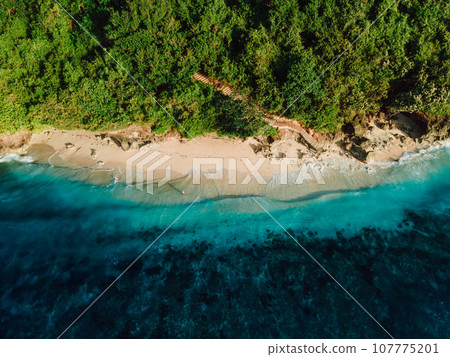 Tropical beach with blue ocean in Bali. Aerial view of Green bowl beach Tropical beach with blue ocean in Bali. Aerial view of Green bowl beach 107775201