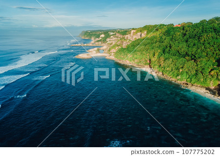 Aerial view of coastline with ocean and beaches under cliffs. Aerial view of coastline with ocean and beaches under cliffs. 107775202