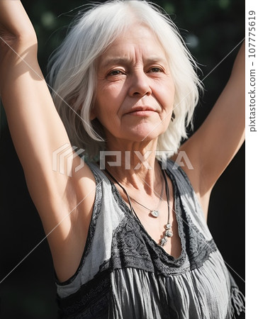 Beautiful senior woman in ethnic fashion with arms raised 107775619