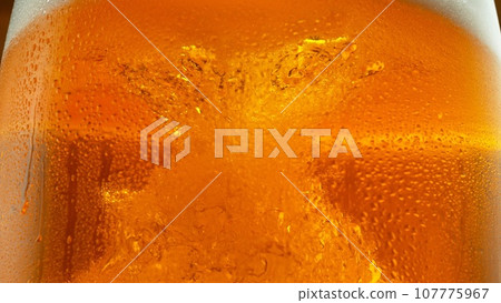 Detail of Pouring Beer Into Glass, Close-up. Detail of Pouring Beer Into Glass, Close-up. 107775967