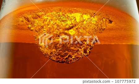 Detail of Pouring Beer Into Glass, Close-up. Detail of Pouring Beer Into Glass, Close-up. 107775972