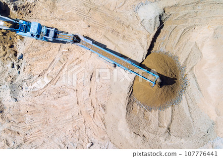 Conveying granite gravel stone in quarry with cone type rock crusher Conveying granite gravel stone in quarry with cone type rock crusher 107776441