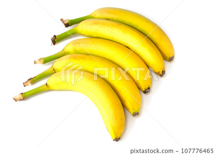 Bananas lie in a row isolated on a white background. Bananas lie in a row isolated on a white background. 107776465