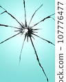 Cracked glass with a hole, broken window texture, bullet hole. 107776477