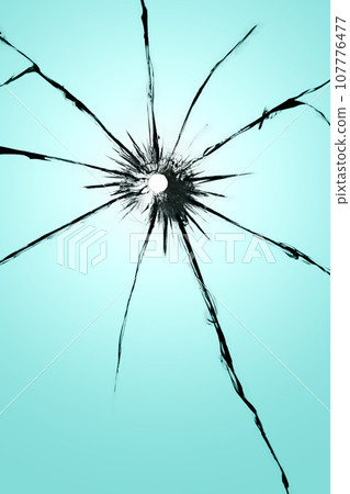 Cracked glass with a hole, broken window texture, bullet hole. Cracked glass with a hole, broken window texture, bullet hole. 107776477