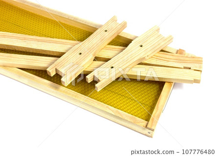 New apiary frame with wax on a white background. Beekeeping equipment for working with beehives. 107776480