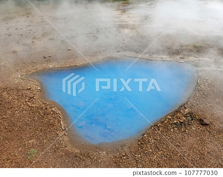 Clear blue hot spring and pool in Geysir geothermal area in Iceland. 107777030