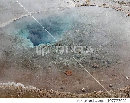 Clear blue hot spring and pool in Geysir geothermal area in Iceland. Clear blue hot spring and pool in Geysir geothermal area in Iceland. 107777031