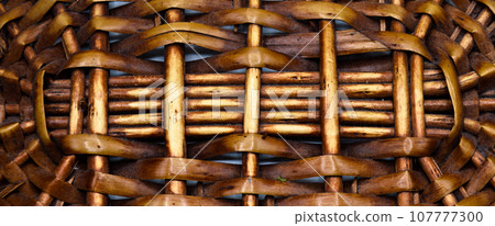 Rattan wicker texture with handmade traditional and dry branches, wicker brown texture background Rattan wicker texture with handmade traditional and dry branches, wicker brown texture background 107777300