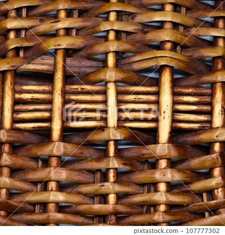 Rattan wicker texture with handmade traditional and dry branches, wicker brown texture background 107777302