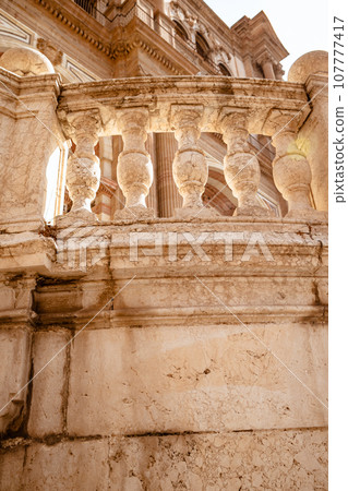 Close up view of architectural details on a famous medieval cathedral in the centre Malaga city in Spain, Europe. 107777417