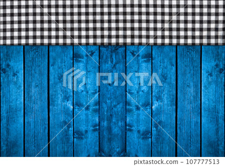 Black white plaid napkin on blue pine wooden floor table or cutting board Black white plaid napkin on blue pine wooden floor table or cutting board 107777513