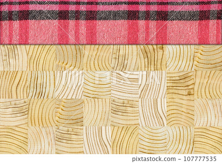 Red black plaid napkin on pine wooden floor table or cutting board Red black plaid napkin on pine wooden floor table or cutting board 107777535
