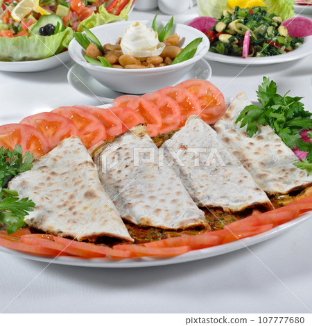 Turkish lahmacun kebap, one of the most important dishes of Turkish cuisine 107777680