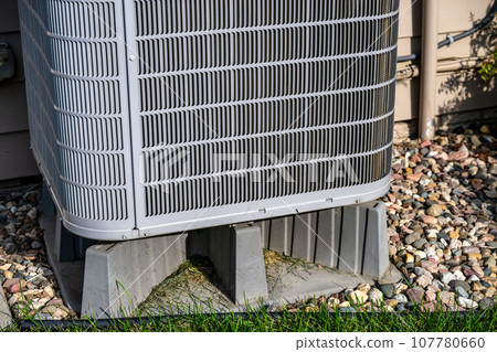 Selective focus on an air conditioner pad to level and hold the unit off the ground. 107780660