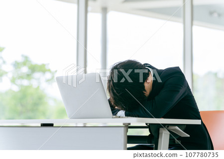 Businessmen/men who are stressed and worried about power harassment, restructuring, workload, and salary in the workplace 107780735