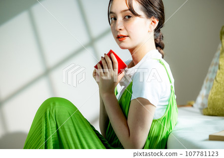 A woman drinking coffee A woman drinking coffee 107781123