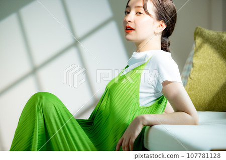 年輕女子坐在沙發上思考 107781128