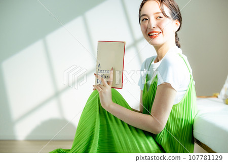 Young woman sitting on the sofa and thinking 107781129