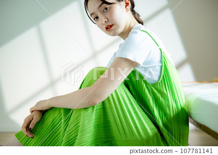 Young woman sitting on the sofa and thinking Young woman sitting on the sofa and thinking 107781141