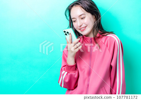 A woman using a smartphone A woman using a smartphone 107781172