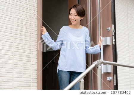A woman opening the door 107783402