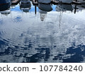 Cloud shadows and ripples on the water surface of the marina 107784240
