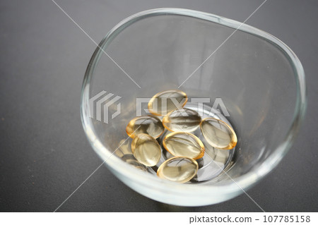 capsules from fish oil in a container capsules from fish oil in a container 107785158