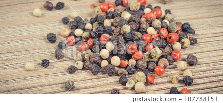 Colored pepper on wooden board as cooking spice 107788151