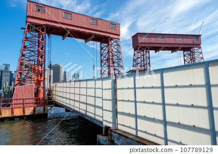 Entrance to Governors Island ferry dock with New York skyline background 107789129