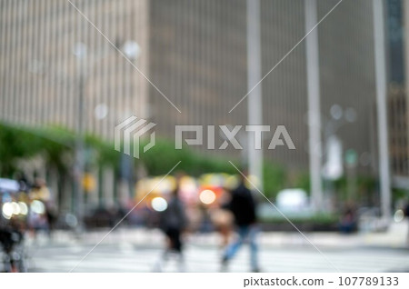 Defocused New York city street scene with pedestrians skyscrapers Defocused New York city street scene with pedestrians skyscrapers 107789133
