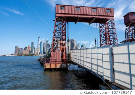 Entrance to Governors Island ferry dock New York skyline background Entrance to Governors Island ferry dock New York skyline background 107789147